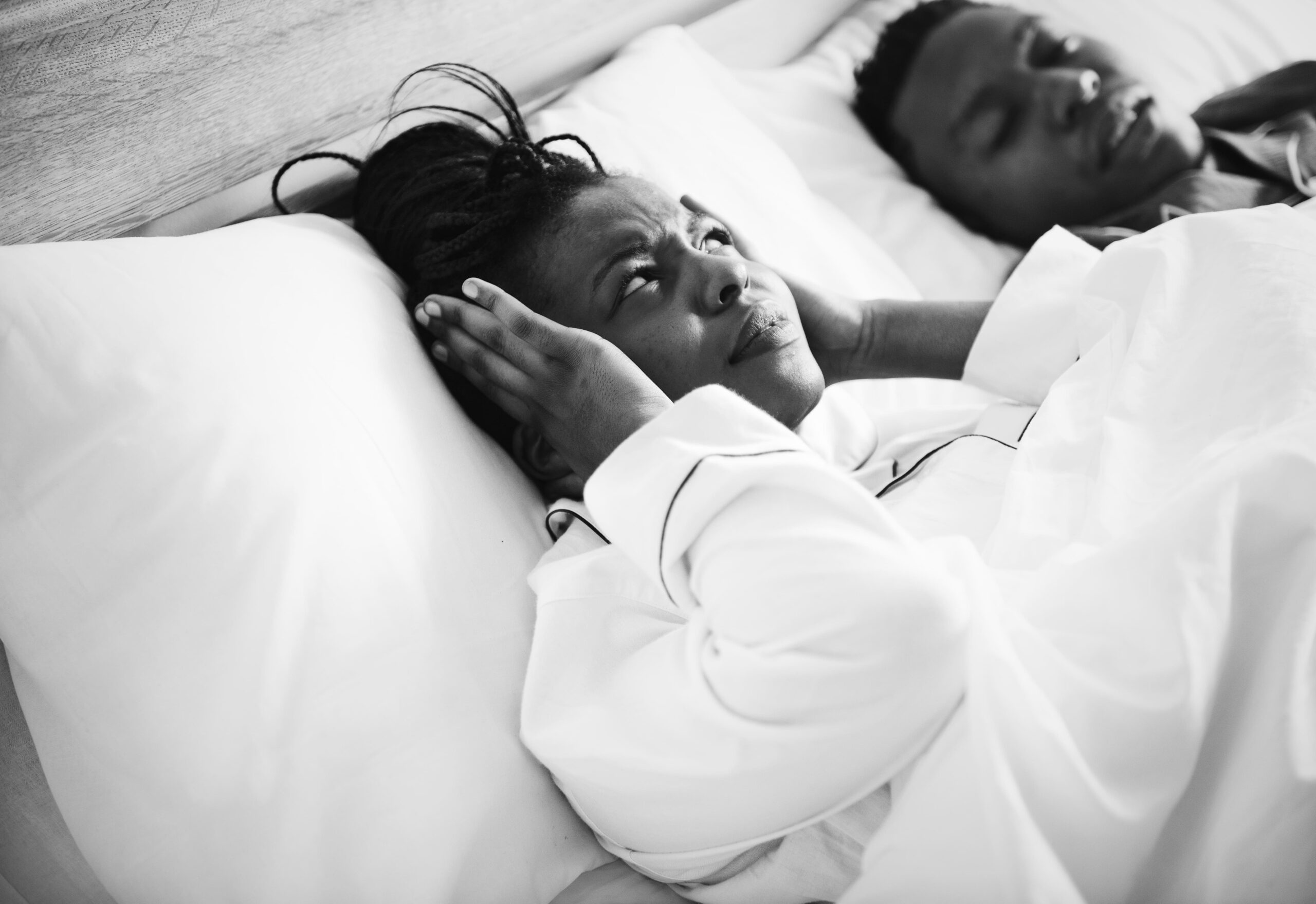 woman-annoyed-while-the-man-is-snoring
